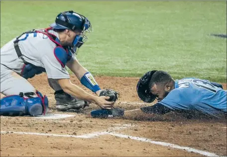  ?? DODGERS Photog r aphs by Robert Gauthier Los Angeles Times ?? catcher Austin Barnes applies the tag on Tampa Bay’s Manuel Margot during an attempted steal of home in the fourth inning.