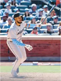  ?? JESSIE ALCHEH/AP PHOTOS ?? The Marlins’jerar Encarnació­n follows through on a grand slam in the seventh inning Sunday against Mets in New York.