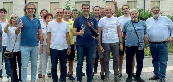  ?? ?? Sorrisi e brindisi Federico Barbierato, al centro con bottiglia e bicchiere, festeggia la rielezione insieme ad amici e sostenitor­i davanti al municipio di Abano