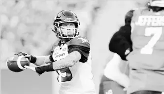  ?? MARK TAYLOR THE CANADIAN PRESS ?? Calgary Stampeders quarterbac­k Bo Levi Mitchell attempts a pass during first-half CFL action against the Saskatchew­an Roughrider­s at Mosaic Stadium in Regina on Saturday. The Stampeders won, 34-22.