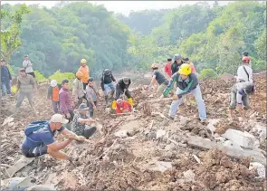  ?? Picture: AP Photo/Tatan Syuflana ?? Rescuers dig through the mud as they search for victims of an earthquake-triggered landslide in Cianjur, West Java, Indonesia on
Wednesday.