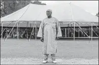  ?? For The Washington Post/WILLIAM WIDMER ?? Shaheed Shabazz, who traveled from Winston-Salem, N.C., for a religious retreat at New Medinah, Miss., stands near a tented community bazaar, where he was selling homemade bean pies, essential oils and books on Islam.