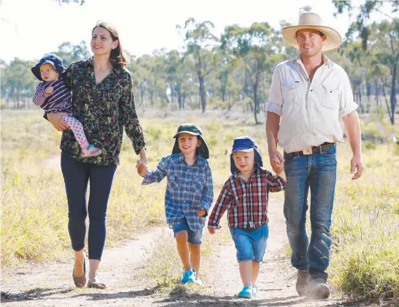  ?? NEW RESPECT: Matt and Sonia Bennetto and their children Elsie, 1, Bruno, 4, and Louis, 3, on their station near Charters Towers. Picture: MICHAEL CHAMBERS ??