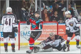  ?? MARISSA BAECKER/Shootthebr­eeze.ca ?? Kelowna Rockets forward Carsen Twarynski (18) celebrates a first-period goal in front of Vancouver Giants netminder Todd Scott during WHL action at Prospera Place on Friday. Twarynski scored in overtime as the Rockets won 5-4.