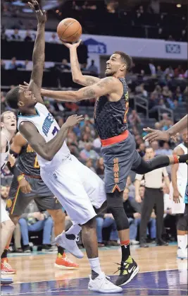  ?? Chuck Barton / The Associated Press ?? Atlanta’s Thabo Sefolosha (right) shoots over Charlotte’s Marvin Williams in Monday’s game.