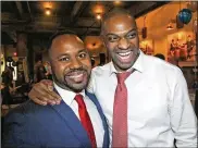  ?? TY GREENLEES/STAFF ?? Common Pleas Court judge candidate Gerald Parker (right) and County Recorder Brandon McClain celebrate their victories on election night at the Montgomery County Democratic watch party.