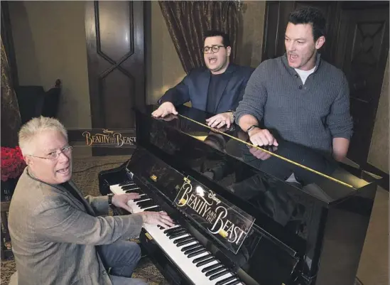  ?? Allen J. Schaben Los Angeles Times ?? CAST MEMBERS of the live action “Beauty and the Beast” Josh Gad, middle, Luke Evans, right, and composer Alan Menken perform a song from the Disney musical.