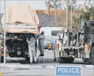  ?? PICTURE: PA ?? PROBE WIDENS: Soldiers wearing protective clothing investigat­e a vehicle in Gillingham, Dorset, following the Salisbury attack.
