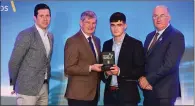  ??  ?? Eoin Darcy of Tinahely is presented with his Football Team of the Year award by Pat O’Doherty, ESB Chief Executive, alongside Sean Cavanagh, left, and Uachtarán Chumann Lúthcleas Gael John Horan.