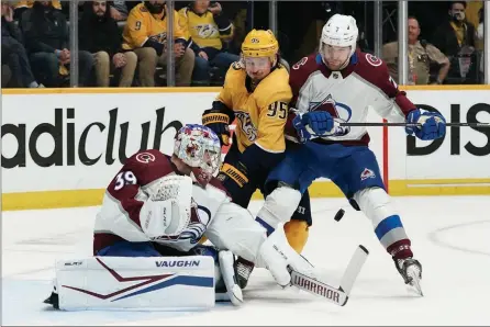  ?? The Associated Press ?? Colorado Avalanche goaltender Pavel Francouz blocks a shot as Devon Toews checks Nashville Predators’ Matt Duchene during the NHL playoffs Monday in Nashville, Tenn.