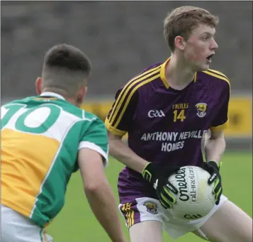  ??  ?? Michael Carroll sizes up his options as Conor McCarthy (Offaly) moves in.