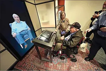  ?? PHOTOS BY GERALD HERBERT / AP ?? World War II veteran Olin Pickens, of Nesbit, Miss., who served in the U.S. Army 805th Tank Destroyer Battalion, looks at the virtual exhibit of himself at the National World War II Museum March 20 in New Orleans.