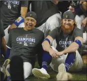  ?? Associated Press ?? UNCERTAIN FUTURE
Dodgers manager Dave Roberts and third baseman Justin Turner pose for a group picture after the Dodgers defeated the Tampa Bay Rays 3-1 in Game 6 to win the World Series on Oct. 27 Arlington, Texas.