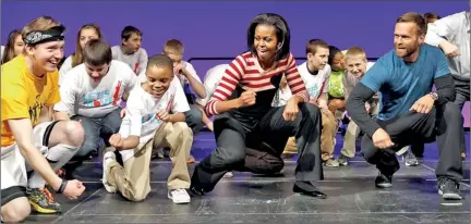  ??  ?? Do the Interlude: The First Lady once again proved she can shake her thing, leading an entire arena in a dance to celebrate the second anniversar­y of her campaign to lower childhood obesity in the U.S. Reuters