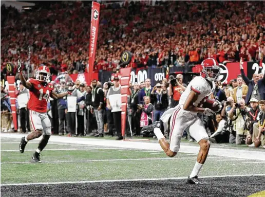  ?? David Goldman / Associated Press ?? After jetting past Georgia defensive back Malkom Parrish (14) to get wide open on second-and-26, Alabama wide receiver DeVonta Smith hauls in the game-winning touchdown pass from Tua Tagovailoa to give the Crimson Tide, who trailed 13-0 at halftime,...