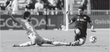  ?? MATIAS J. OCNER mocner@miamiheral­d.com ?? Inter Miami forward Leonardo Campana, left, slide tackles against New England Revolution midfielder Matt Polster.