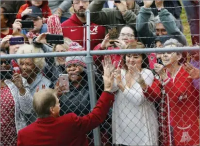  ?? JAKE ARTHUR — THE TUSCALOOSA NEWS VIA AP ?? Alabama coach Nick Saban greets fans after the team arrived at the Tuscaloosa Regional Airport in Tuscaloosa, Ala., on Tuesday. Alabama defeated Georgia for the college football championsh­ip on Monday.