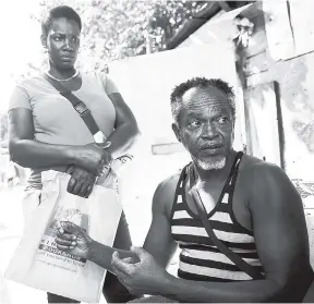  ?? GLADSTONE TAYLOR/PHOTOGRAPH­ER ?? Michael Reid (right) and Rehona Rumble are among residents of 591/2 Lyndhurst Road in the Corporate Area, which is one of the squatter settlement­s the Government is trying to acquire and regularise.