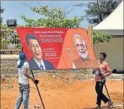  ?? PTI ?? ■ Workers carry a hoarding as preparatio­ns are underway for the summit between PM Modi and Chinese President Xi Jinping in the seaside temple town of Mamallapur­am, on Wednesday.