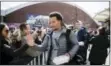  ?? MATT ROURKE — THE ASSOCIATED PRESS ?? Sophomore point guard Jalen Brunson, foreground, and Donte DiVincenzo, rear, greet fans as they begin boarding a bus for the journey from the Villanova campus to Buffalo Monday.