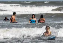  ?? Michael Ciaglo / Houston Chronicle ?? Brandon Ogle, 13, surfs with a boogie board as his family from Sioux City, Iowa, spends the holiday weekend in Galveston.