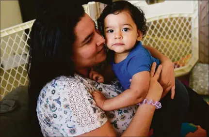  ?? Tyler Sizemore/Hearst Connecticu­t Media ?? Karina Mendez holds her son, Samuel, 15 months, at their home in Norwalk on Nov. 22.