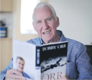  ?? A A R O N H I N K S / D A I LY N E WS ?? Royce Tennant holds a copy of Orr: My Story, for which he wrote the foreword at Bobby Orr’s request. Tennant turned a young Orr into a defenceman from a forward.