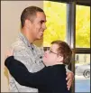  ?? JAMIE BURNETT/377TH AIR BASE WING ?? First Lt. Eddie Cruz of the 58th Special Operations Wing, left, hugs Chris Logan of Jeremiah’s Place school at his recent promotion ceremony. Cruz included students from the school for young people with developmen­tal disabiliti­es in his ceremony.