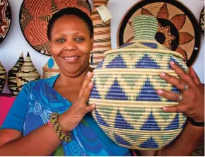  ??  ?? Janet Nkubana of the Gahaya Links Cooperativ­es in Rwanda is seen at the Internatio­nal Folk Art Market.