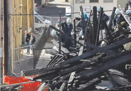  ?? Joe Amon, The Denver Post ?? Denver fire and investigat­ors clear rubble Thursday from the fire at the Emerson Street constructi­on site that caused damage to 13 other buildings, forcing residents and businesses to be displaced.