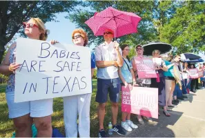  ?? ?? Linda Banes, left, and Ethelene Marshall stand with anti-abortion demonstrat­ors as they gathered to sing and pray outside Planned Parenthood in Houston, June, 24, 2022, after the U.S. Supreme Court overturned Roe v Wade.