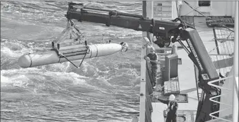  ?? AUSTRALIAN DEFENCE FORCE / HANDOUT VIA REUTERS ?? The Bluefin-21 unmanned mini-sub is craned over the side of the Australian navy’s OceanShiel­d in the southern Indian Ocean to search for the Malaysia Airlines flight MH370 on Thursday. The US navy says the sub will need six weeks to two months to scan...