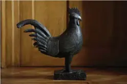  ?? — AFP ?? Photo shows a bronze statue of a cockerel - one of what are known as the Benin Bronzes, which were looted from the former kingdom of Benin by the British in the 19th century, at Jesus College at Cambridge University in Cambridge, north of London.