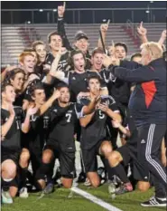  ??  ?? Boyertown head coach Scott Didyoung hands the PAC championsh­ip plaque to his players after they won the championsh­ip Thursday in a 3-1 win over Pottsgrove.