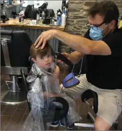  ??  ?? Finn gets his long-awaited haircut in The Urban Barbers in Bunclody.