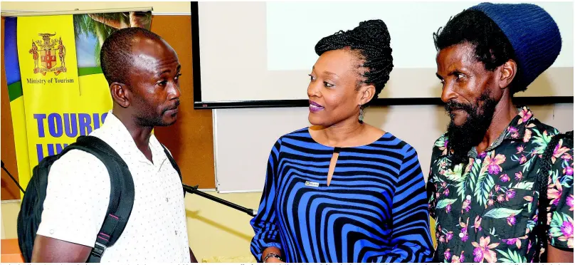  ?? CONTRIBUTE­D ?? Nickeisha Cleary (centre), retail sales manager, JN Bank, discusses available opportunit­ies to coffee farmers with Shane Brown (left) and Milton Francis. They were attending the Jamaica Blue Mountain Coffee Festival, which was held at the University of Technology in Papine, St Andrew, on March 1.