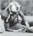  ?? RICHARD SHIRO, AP ?? South Carolina’s Marcus Lattimore grabs his knee in a 2012 game.