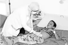  ?? — Reuters photo ?? File photo shows Nahla Arishi, a pediatrici­an, checks a boy infected with diphtheria at the al-Sadaqa teaching hospital in the southern port city of Aden, Yemen.