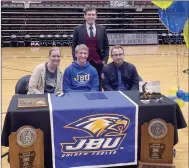  ?? Graham Thomas/Siloam Sunday ?? Siloam Springs senior Sam Jackson signed to play soccer Wednesday at John Brown University. Pictured are mother Nancy Jackson, Sam Jackson, and father Mark Jackson along with head coach Luke Shoemaker, back.