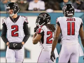  ?? CURTIS COMPTON/CCOMPTON@AJC.COM ?? Matt Ryan, Devonta Freeman and Julio Jones (seen here playing in Philadelph­ia back in January) will be practicing in Flowery Branch on Monday morning in one of the few sessions open to the public.