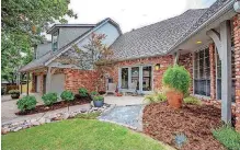  ?? [PHOTOS PROVIDED] ?? Side entrance and patio off the eat-in kitchen at the Listing of the Week, 2340 Deborah Lane in Edmond.