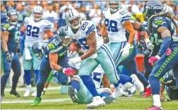  ?? OTTO GREULE JR/GETTY IMAGES ?? DeMarco Murray, center, of the Dallas Cowboys rushes for the winning touchdown in a 30-23 win over the Seattle Seahawks.