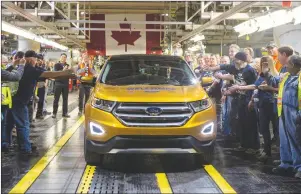  ??  ?? Ford Motor Company President of the America’s Joe Hinrichs drives the first car to the end of the production line as Ford Motor Company celebrates the global production start of the 2015 Ford Edge at the Ford Assembly Plant in Oakville, Ont.