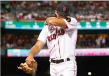  ?? AP Photo/Paul Connors ?? ■ Boston Red Sox pitcher Michael Wacha wipes his face as he walks off the mound against the New York Yankees during the seventh inning at Fenway Park on Sunday in Boston.