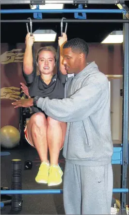  ?? LESLEY YOUNG /SPECIAL TO THE COMMERCIAL APPEAL ?? Rachel Hyneman, 18, of Eads, works on ab exercises with her personal trainer, Mario Myles, at BIOMechani­ks in Germantown. Hyneman was involved in a car accident in 2009, and her recovery included learning how to walk again. Now she trains for life.