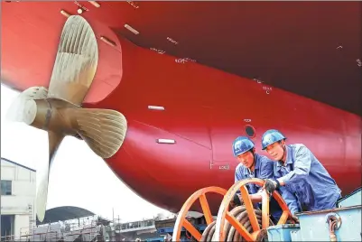  ?? PROVIDED TO CHINA DAILY ?? Workers prepare a newly built bulk carrier for its launch at a shipyard in Nanjing, Jiangsu province.