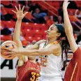  ?? [AP PHOTO] ?? Oklahoma State guard Loryn Goodwin (32) drives between Iowa State forwards Meredith Burkhall (32) and Adriana Camber (13) during the first half of Wednesday night’s game at Gallagher-Iba Arena in Stillwater.