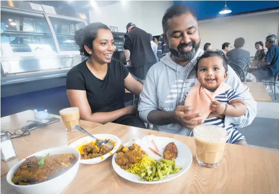  ?? Photos / Jason Oxenham ?? Yogi and Prasanna Kumar with baby Eeshan, dining at Kedai Mamak. Below: Owners Amanda Annie and Robin Annadass.