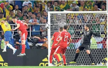  ??  ?? A defender rises: Brazil’s Thiago Silva (left) heading in the second goal against Serbia in the Group E match at the Spartak Stadium on Wednesday. Inset: Thiago Silva is hugged by Neymar. — AFP / AP