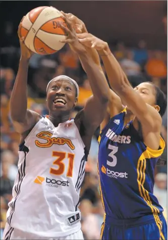  ?? SEAN D. ELLIOT/THE DAY ?? Tina Charles of the Sun, left, is fouled by Candace Parker of the Sparks during the second half of Wednesday night’s WNBA game at Mohegan Sun Arena.